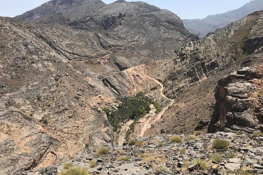 A rugged mountainous landscape with a winding dirt path. 2