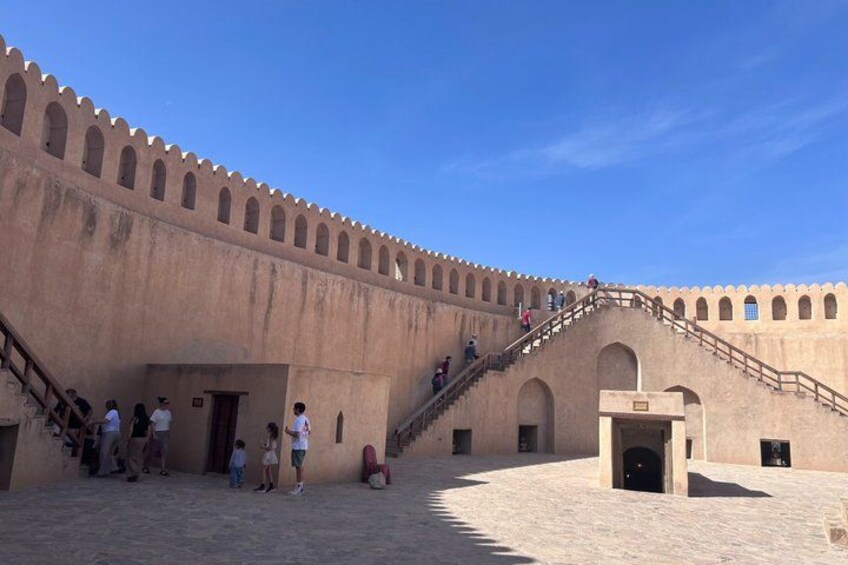 A historical building with a large staircase and arched doorways. 4