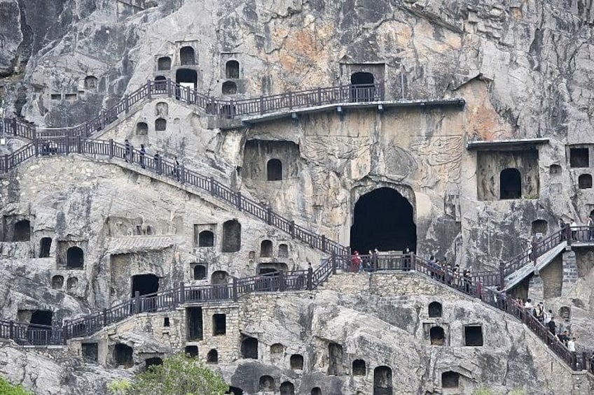 A rock formation with multiple caves and staircases. 4