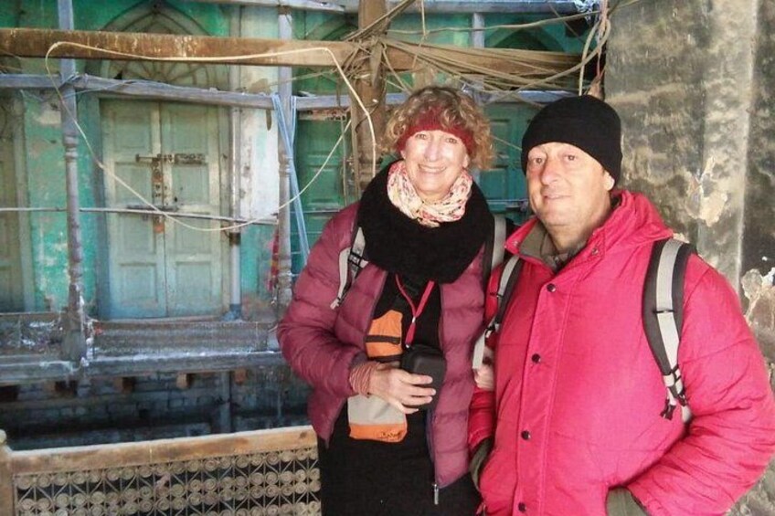 Two people standing in front of a building with scaffolding. 4