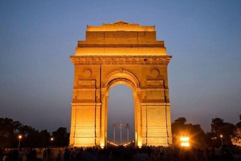 A large illuminated arch structure at dusk. 3
