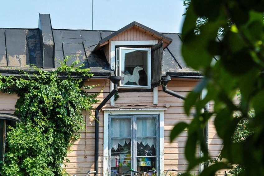 A house with a window, a door, and a small balcony. 3