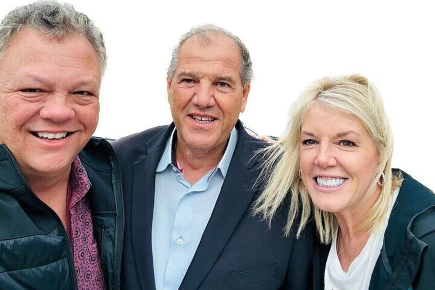 Three people standing close together. 5