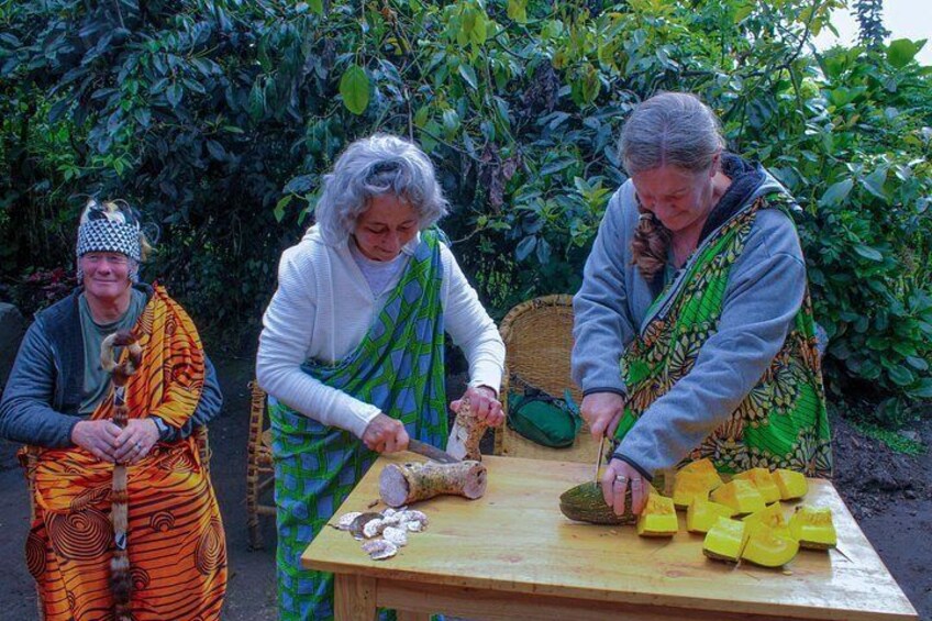 Three people cutting fruits on a wooden table outdoors. 4