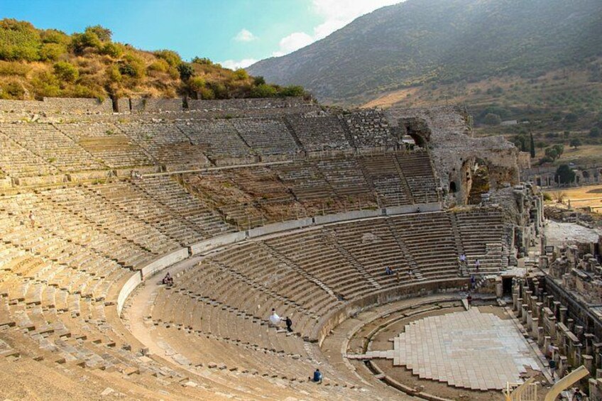 An ancient amphitheater with tiered seating and stone structures. 3