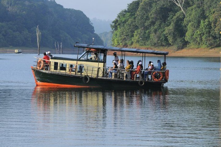 A boat with passengers on a calm river, surrounded by lush greenery. 2