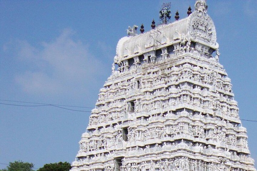 A detailed, multi-tiered temple with intricate carvings and a spire on top. 2