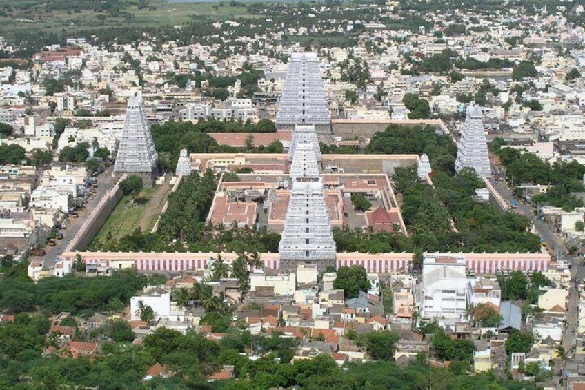 An aerial view of a city with a prominent temple complex featuring tiered pyramids and a central courtyard. 3