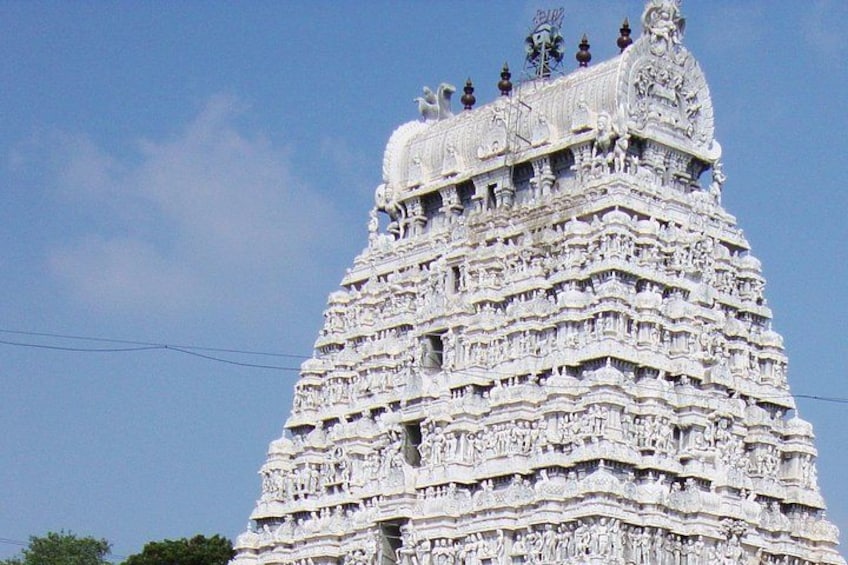 A detailed temple tower with multiple tiers and intricate carvings. 2