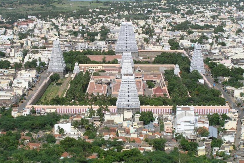 A temple complex with multiple spires and surrounding residential areas. 3