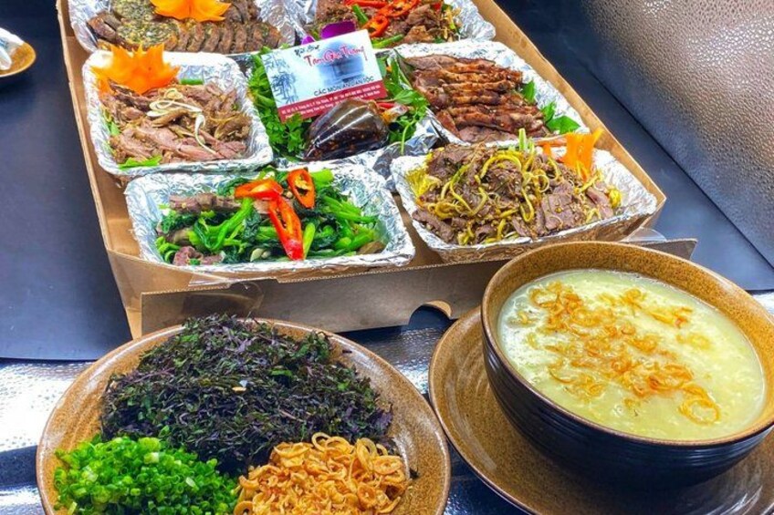 A variety of food items in aluminum trays and bowls, including different types of meat and vegetables. 2