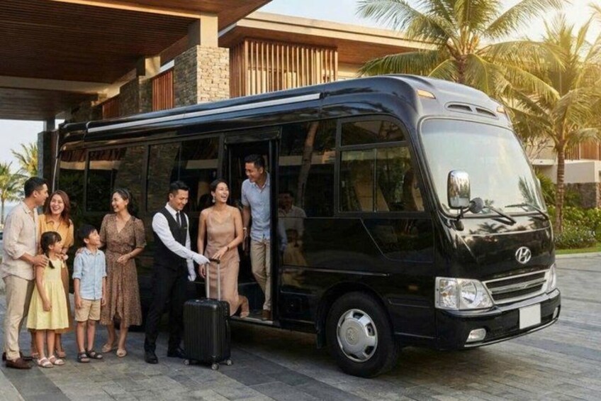 A black bus parked in front of a building with people standing outside. 4