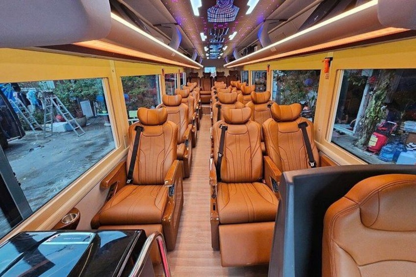 A train interior with leather seats and large windows. 5