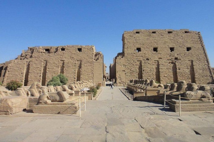 Ancient stone structures with a clear pathway leading towards them. 4