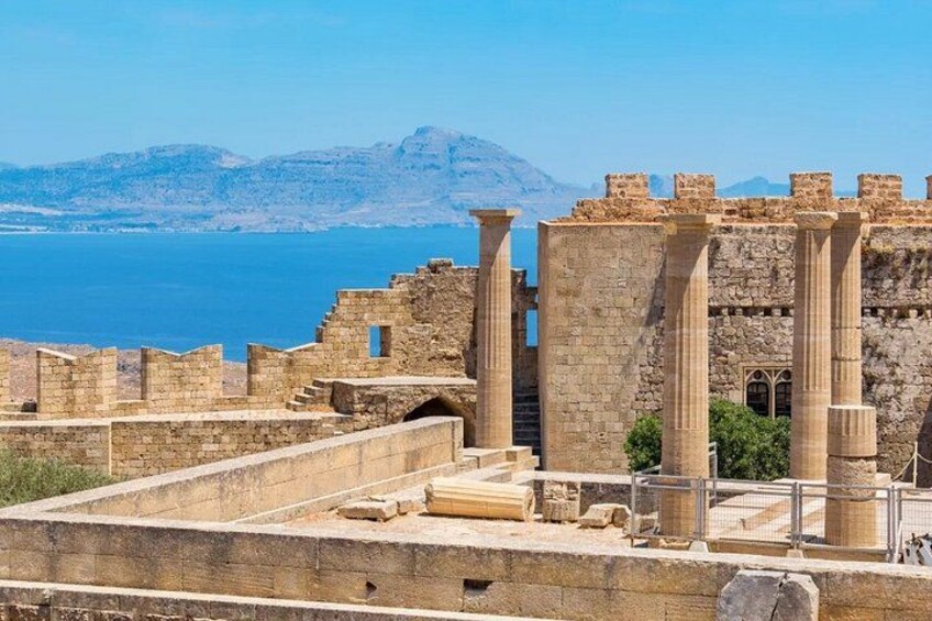 Ancient ruins with columns and a view of the sea. 4