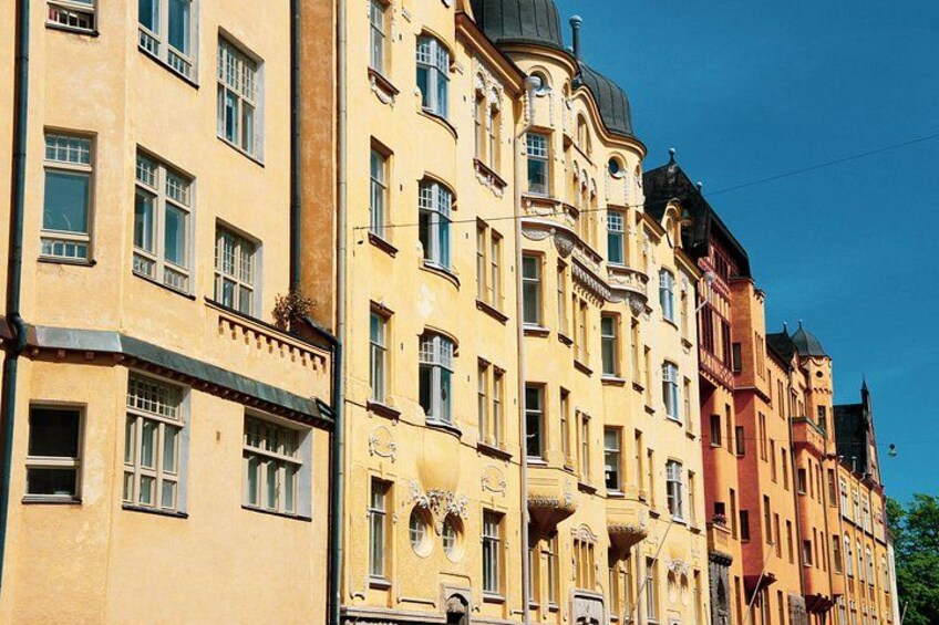 A row of historic buildings with ornate facades and large windows. 2