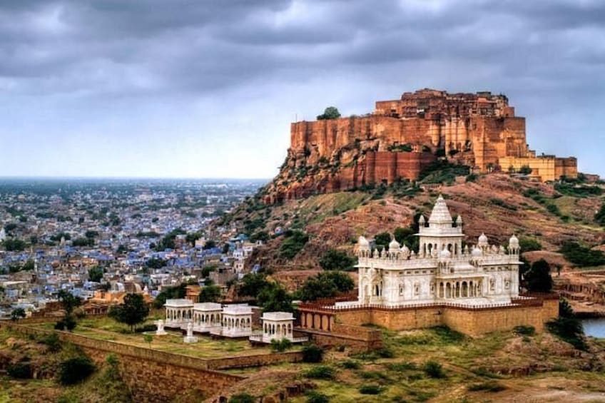 A historic fort on a hill, a white palace with domes, and a cityscape in the foreground. 1