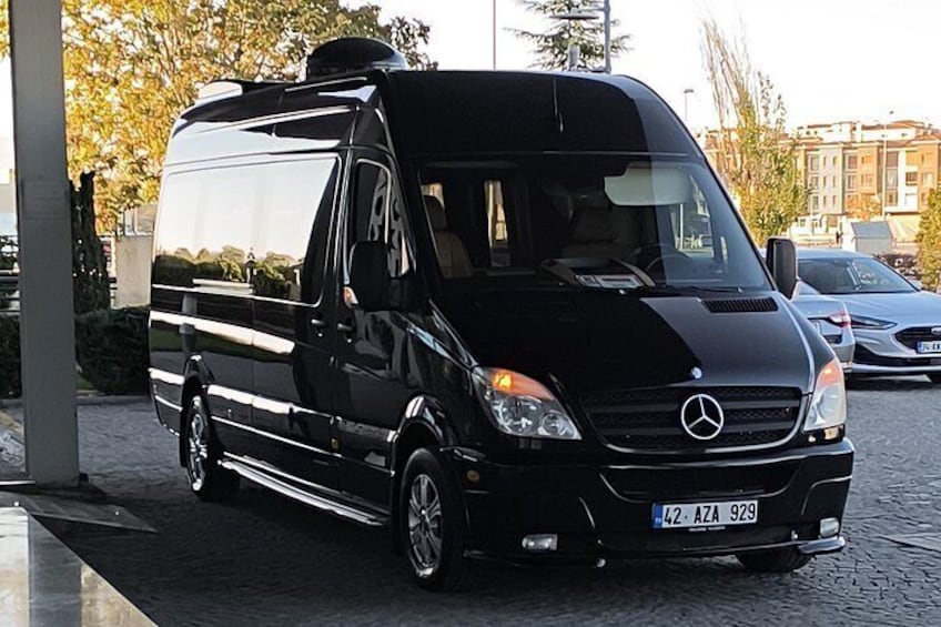 A black Mercedes van parked on a cobblestone street. 3