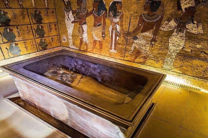 An ancient Egyptian sarcophagus with hieroglyphs and a mummy inside. 2