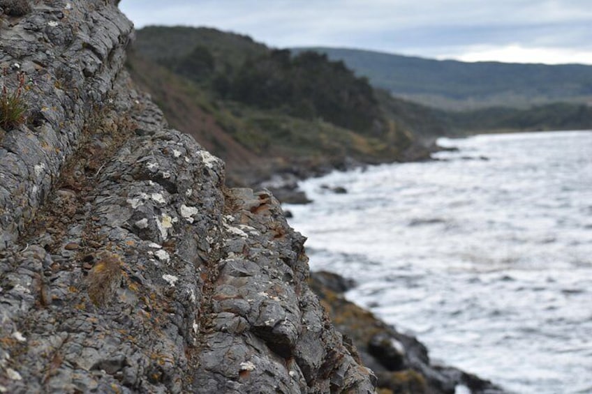 A rocky coastline with waves crashing against the shore. 4