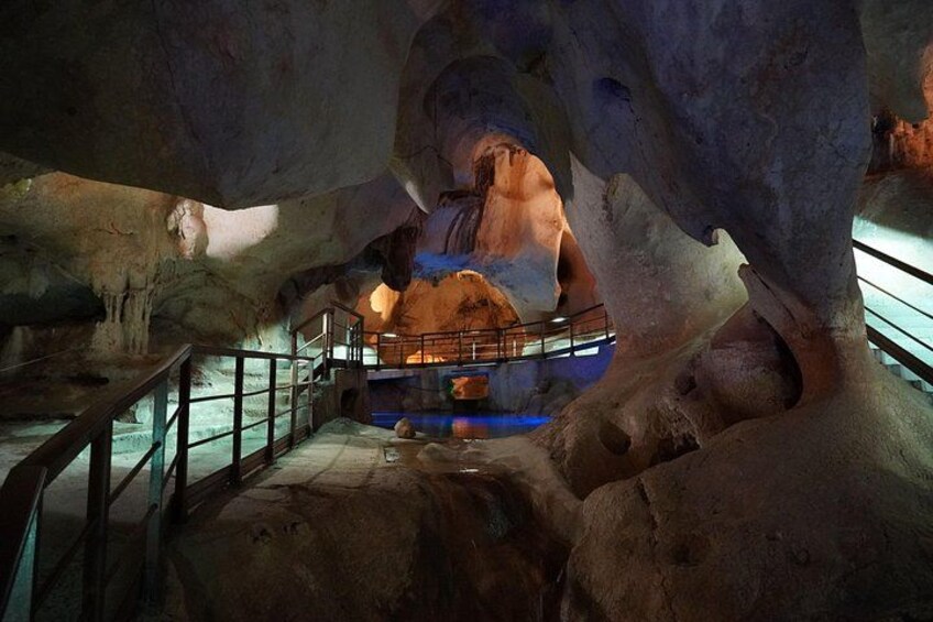 An underground cave with stalactites and a viewing platform. 1