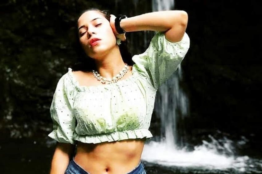 A person standing in front of a waterfall. 5