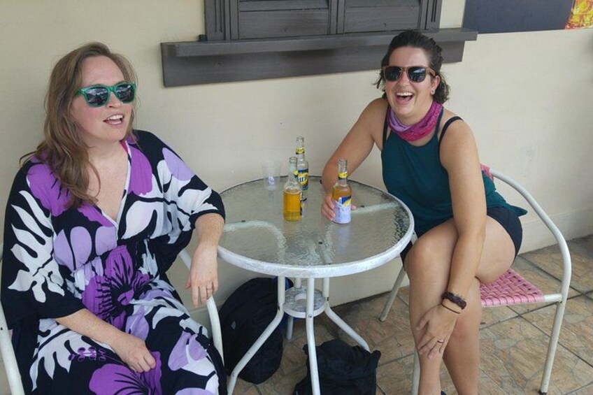 Two people sitting at a round table with drinks. 2