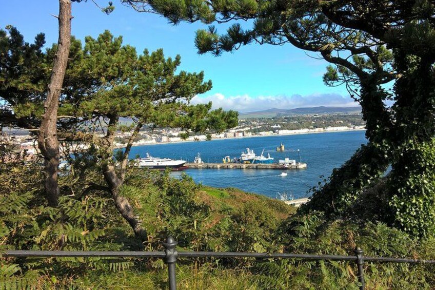 A coastal landscape with a pier, boats, and a clear blue sky. 3