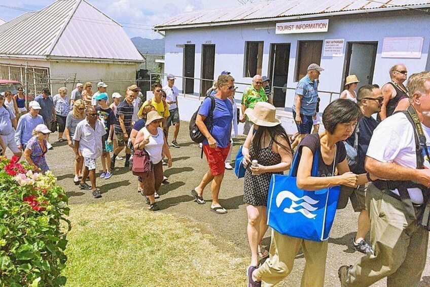A group of people walking towards a building labeled 'Tourist Information'. 5