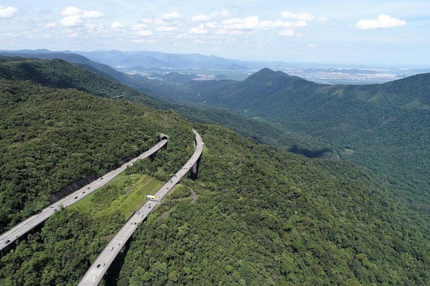 A highway winding through a mountainous landscape with lush greenery. 2