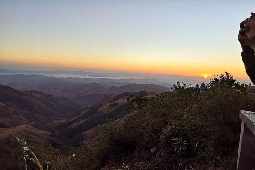 A mountainous landscape with a sunset in the distance. 5