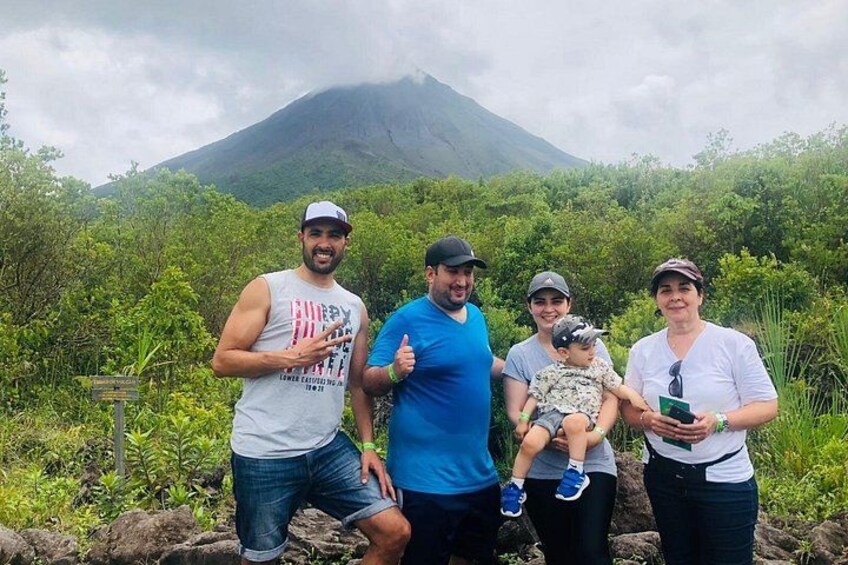 A family of four outdoors with a mountain in the background. 3