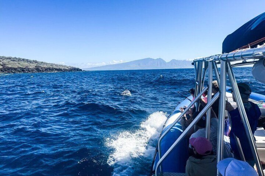 A boat on a clear blue sea with mountains in the background. 2