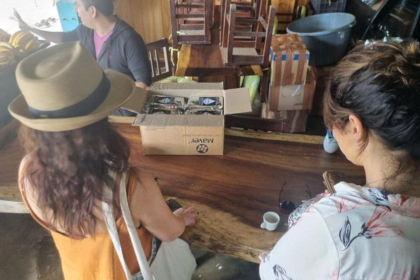 A wooden table with a box labeled 'JARVIS' and a person wearing a hat. 2