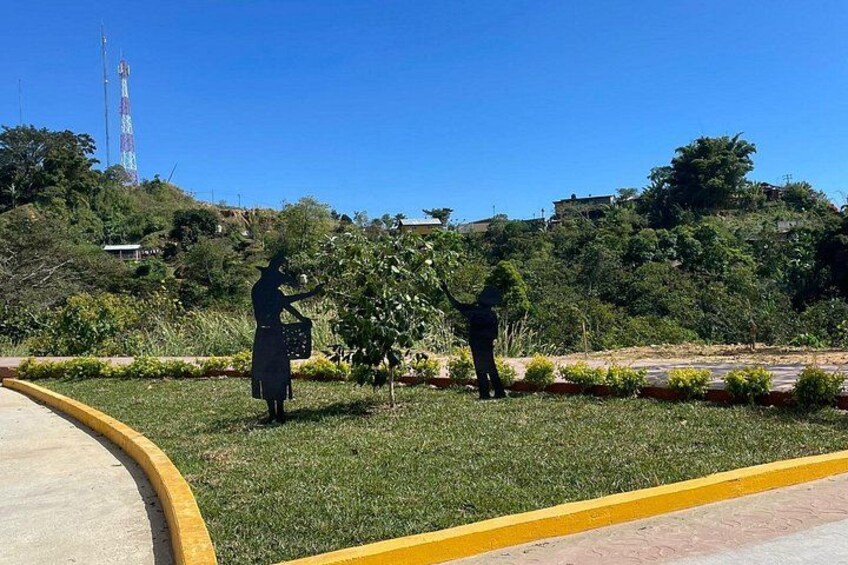 A statue of a person in a long skirt and a child in a playground. 3