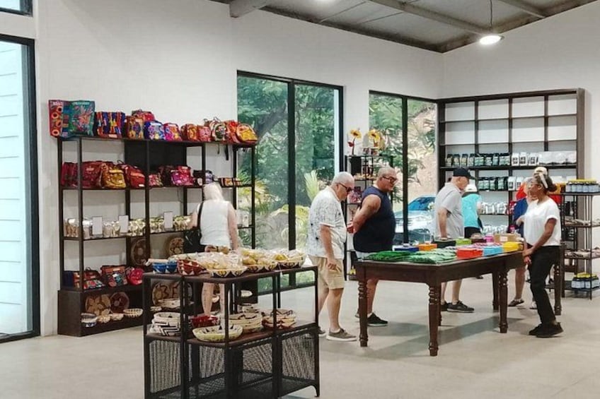 A store with shelves of colorful bags and a table with folded items. 4
