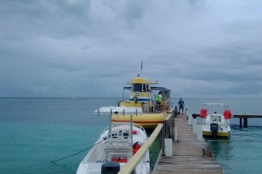A pier with a yellow boat docked and a white boat nearby. 5