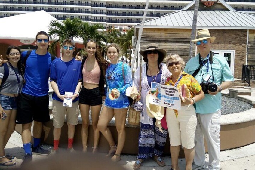 A group of people posing for a photo in front of a building with a sign that reads "Holly's Diner." 1