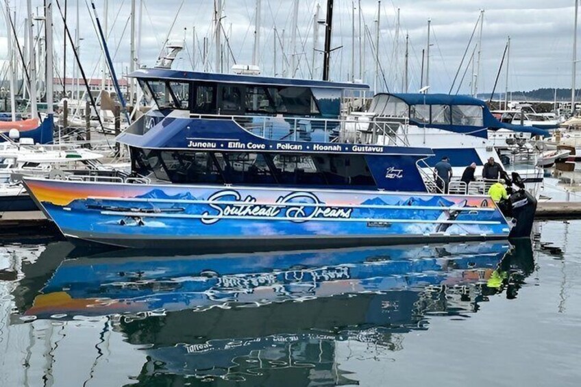A boat named 'Southeast' docked at a marina with other boats and a cloudy sky. 2