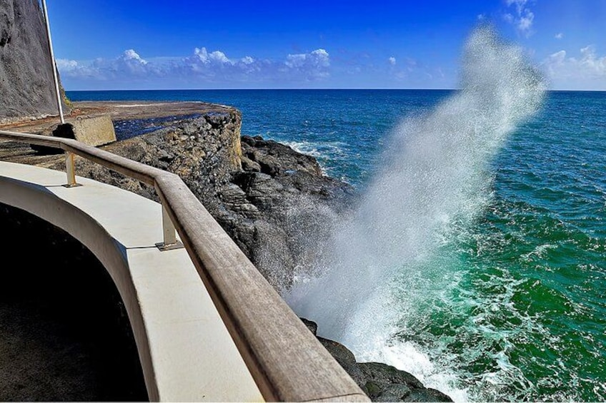A rocky coastline with waves crashing against the shore. 2