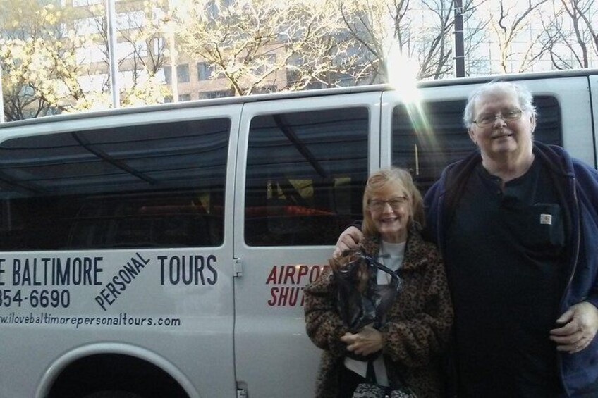A white van with text and logos, including "BALTIMORE TOURS" and "AIRPORT SHUTT." 5