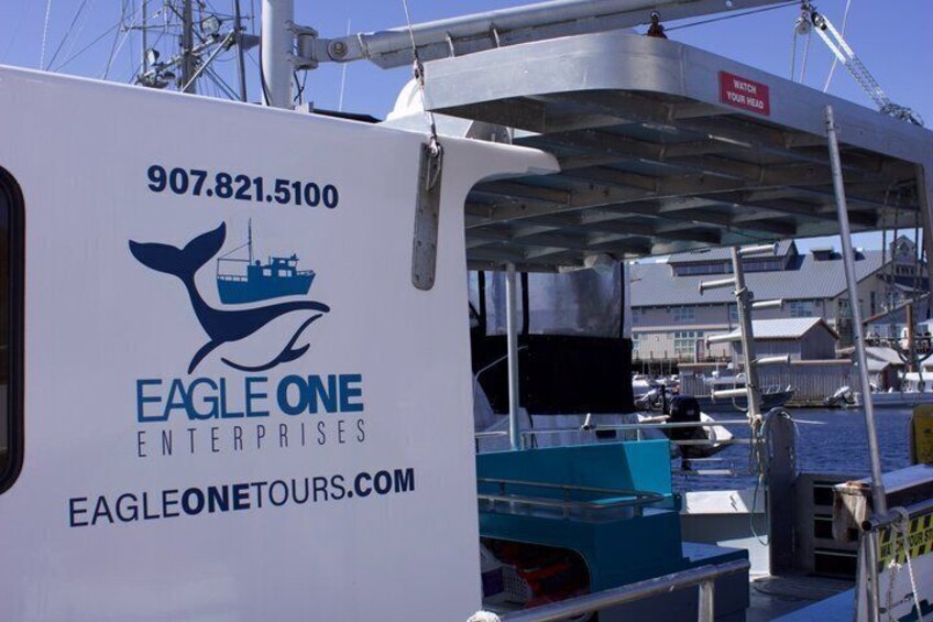 A boat with the text 'EAGLE ONE ENTERPRISES' and a phone number. 2