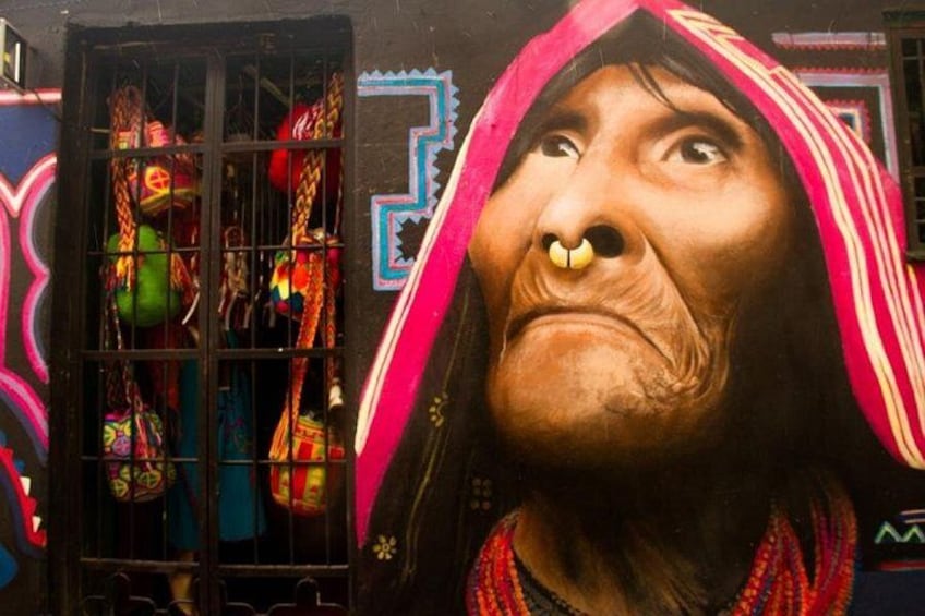 A mural of a person with a large nose and a colorful headdress. 2