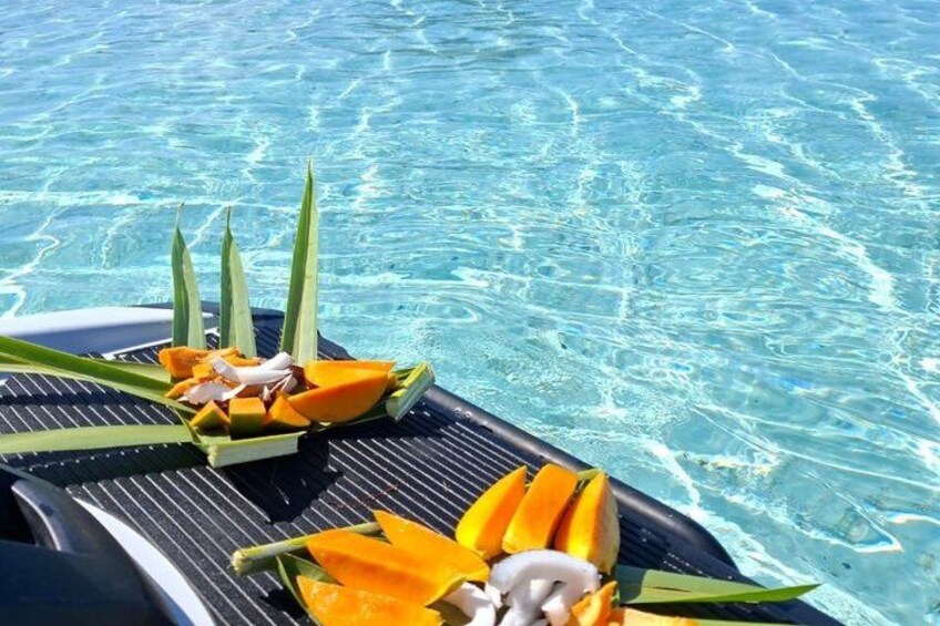 A pool with clear water and a floating platform with fruit and leaves. 3