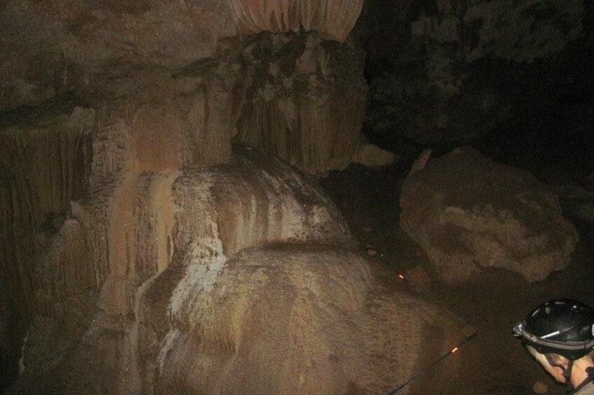 A cave interior with stalactites and stalagmites. 5