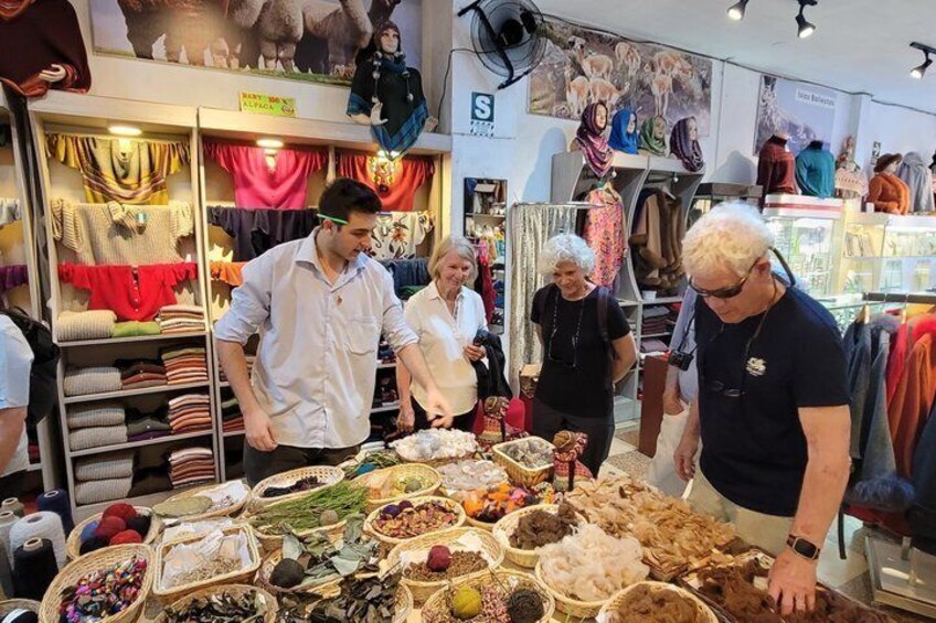 A market stall with various textiles and fabrics on display. 5
