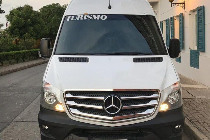 A white Mercedes van with "TURISMO" on the windshield. 5