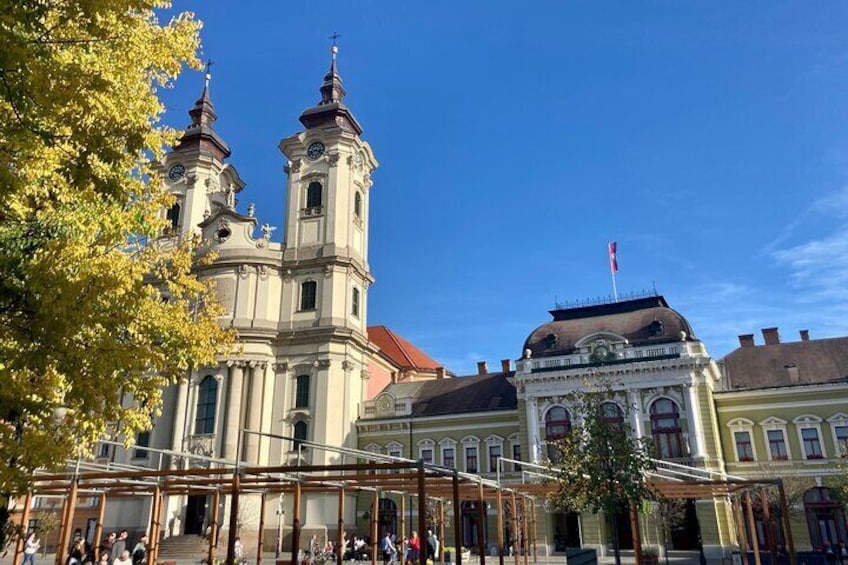 A historic church with two towers and a domed building in the background. 3