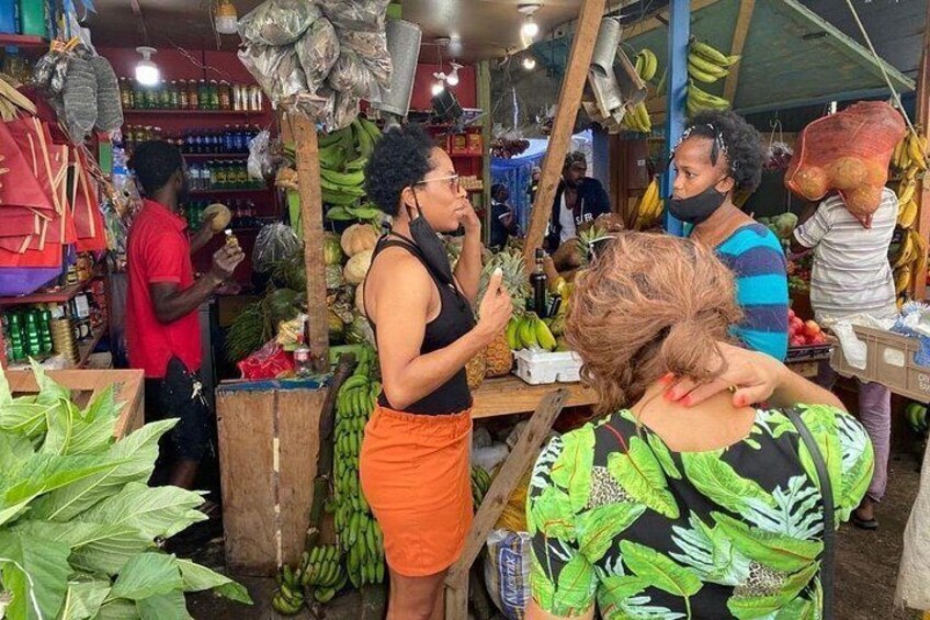 A market with people shopping and vendors selling goods. 1