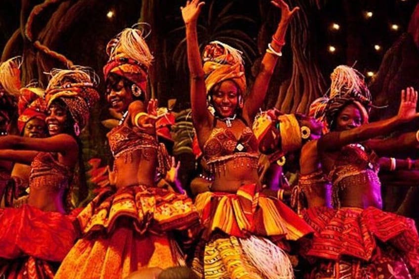 Un groupe de danseurs, vêtus de costumes traditionnels, se produit sur scène. 1